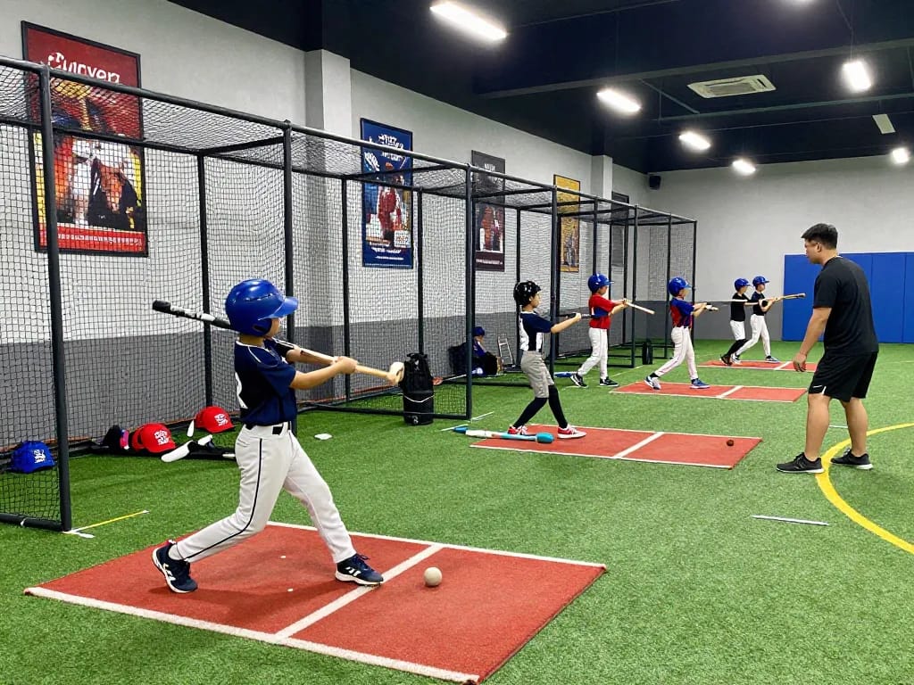 Hitclub indoor baseball training with young athletes practicing swings in vibrant facility.